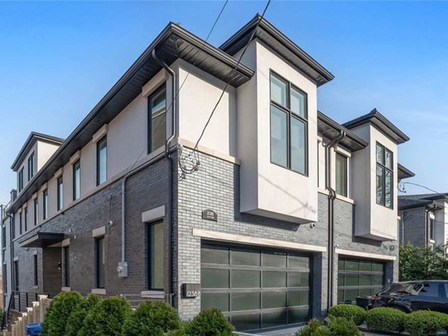 Meticulously crafted 5,000 square foot townhome by Rock Solid Builders. Spanning four levels, this home boasts 4 bedrooms, each complemented by its own lavish ensuite. The living room, adorned with a bespoke stone fireplace, features soaring 10-foot ceilings and floor-to-ceiling windows offering views of the Hudson River. Gourmet kitchen w/ complete with professional-grade appliances, perfect for culinary enthusiasts. Ascend to the master suite, where a cozy fireplace awaits alongside spa bathroom and built-in closet. The pinnacle of sophistication awaits on the top floor, where a family room and half bath lead to an expansive roof deck, commanding breathtaking panoramas of New York City to the George Washington Bridge. The ground level boasts vaulted ceilings, bedroom, full bath, and direct backyard access, seamlessly blending indoor and outdoor living. Smart home is equipped with modern amenities such as a Crestron system, automated blinds, two-car garage, elevator.