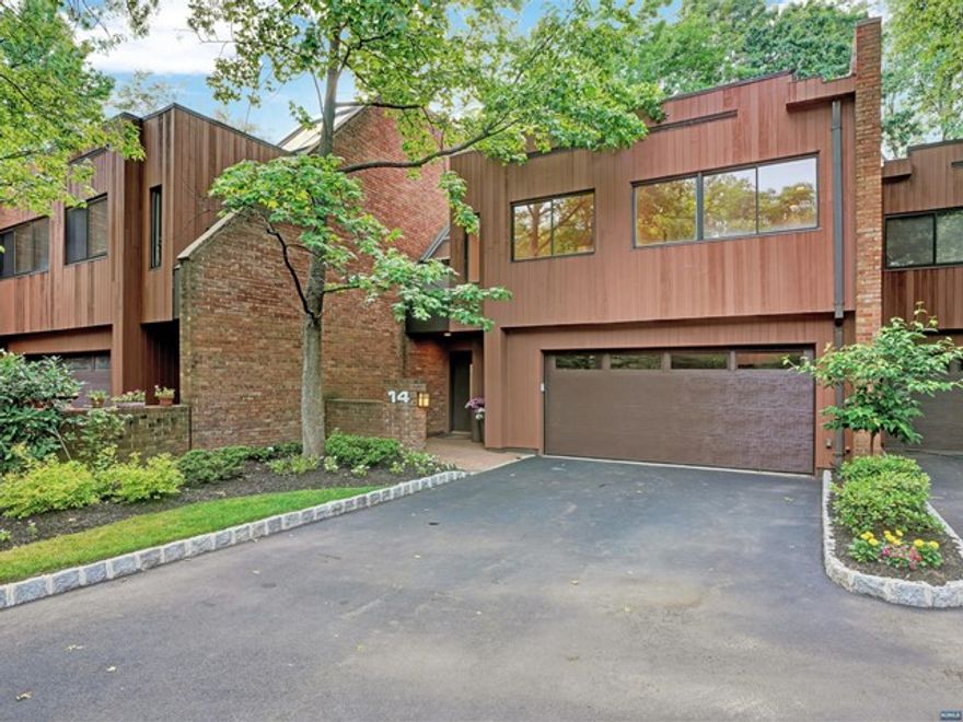 Rare Opportunity!!! Spectacular Townhouse located at the exclusive Summit Woods complex with stunning sunset views overlooking Flat Rock Brook Nature Preserve. Sun-drenched two story entrance foyer with skylights, fabulous open layout with living room, dining room, kitchen with breakfast room and walls of windows, two large bedrooms on their own floor with bath and laundry room. Private primary bedroom suite with sitting area, custom built walk-in closet and full bath. Walk-out lower level offers a family room with a fireplace, bonus room/office and serene outdoor patio. Enjoy relaxing summers at the heated in ground pool and spa, all just minutes to the GWB&NYC.