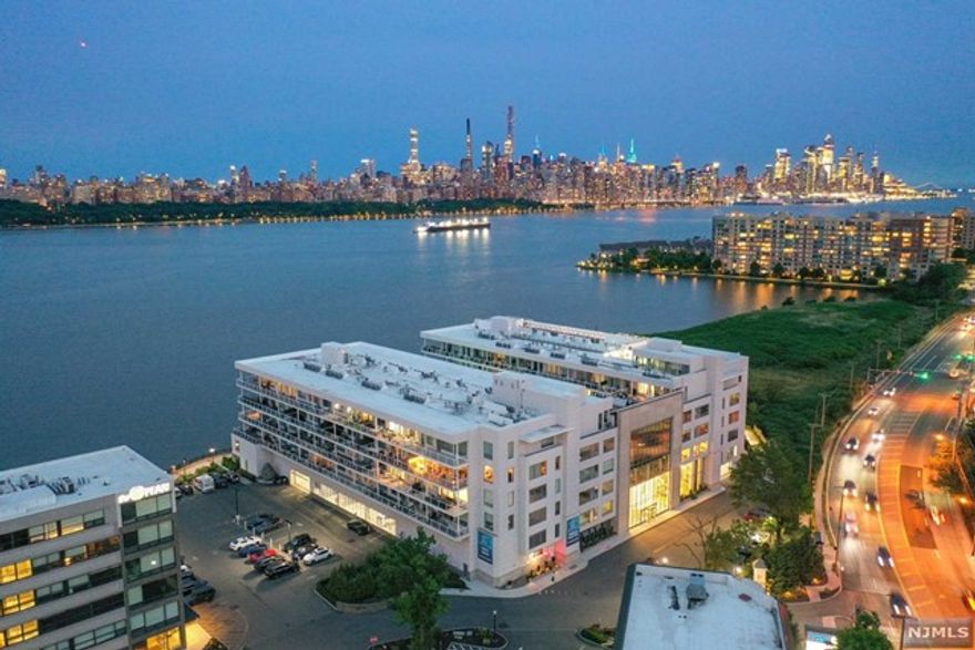 Discover luxury in this 2-bedroom, 2-bath residence, boasting breathtaking Manhattan views. Elegance is evident in the expansive Marvin windows, 10 ft. ceilings, and hardwood floors. The gourmet kitchen highlights elite Subzero, Wolf, and Bosch appliances, alongside Caesarstone countertops. Relish in spa-like bathrooms and innovative Smart Home features. Included amenities: secured garage parking, a Manhattan-facing heated pool, rooftop lounging with fire pits & and BBQs, a state-of-the-art fitness center, a cinematic movie room, and a playful children's space. Adjacent to Public Riverwalk Park, a private pier, 24-hour concierge, ferry shuttle, NYC bus access, and gourmet dining. Experience the essence of luxury living. 2 parkings included