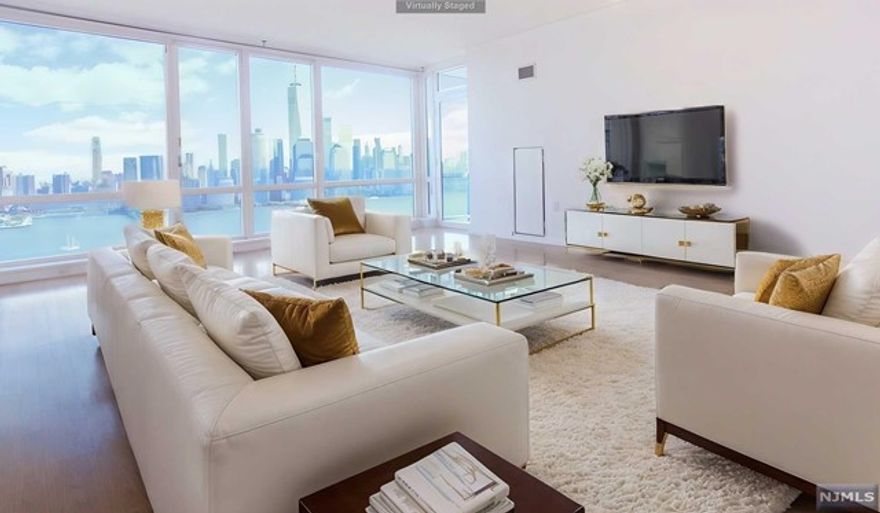 Welcome to Jersey City's finest, luxury waterfront 2 bedroom, 2 bathroom home, with a wall of floor to ceiling windows boasting breathtaking direct views of the Manhattan skyline and Hudson River from every room. Enjoy morning coffee or evening drinks from your private balcony overlooking NYC. This home features hardwood flooring throughout an ultra sleek Kitchen with Pedini cabinets, glass accents, quartz countertops, tiled backsplash, breakfast bar and stainless steel appliances, marble accented bathrooms, in unit washer/dryer, CAC, Valet parking. Situated next to the boardwalk, close to the Light Rail, PATH & ferry, Crystal Point features a 24-hr concierge, pool, spa, hot tub, fitness room, community room, media room, outdoor deck with BBQ grills, kids play area & much more!