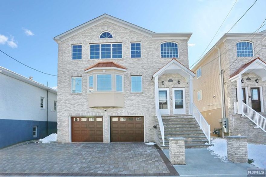 Welcome to this luxurious 3-bedroom, 2-full bath rental on the second floor of a less-than-4-year-young, two-family home in a highly desirable neighborhood. Step inside to discover an open floor plan, vaulted ceilings, crown molding, and high-quality hardwood flooring throughout. The primary bedroom offers a retreat with a full bath and a walk-in closet, while two additional spacious bedrooms and a hallway main bath provide ample space for guests or family members. The kitchen is a chef's dream with stainless steel appliances, custom cabinetry, granite countertops, and a wine fridge. Enjoy the convenience of in-unit laundry, a ring doorbell, and yard access. Parking is hassle-free with one indoor garage space and driveway parking. Plus, take advantage of easy access to major highways for a quick commute to NYC, with a nearby bus stop and train station. Don't miss out on this exceptional rental opportunity! Schedule a viewing today.