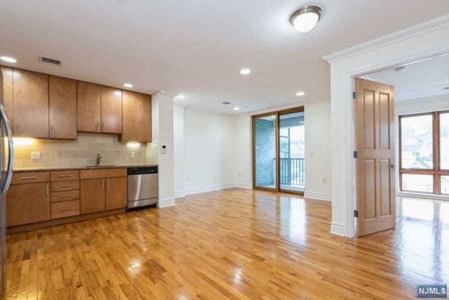 Welcome to The Gate! Spacious 678, open-concept 1BD/1BA apartment in a 5 story, modern, brick, elevator building just one block from Rutherford train/bus station and walking distance to downtown area. Each unit offers solid oak doors, crown and base moldings, granite counter tops, stainless steel appliances, washer/dryer in unit, keyless entry, private balcony, central A/C, and video phone intercom. Pet friendly (40lb limit) and no pet fee. A must see!! Gated parking available for a fee. PHOTOS ARE OF UNIT SIMILAR UNIT (406) KITCHEN & BATHROOM FINISHES ARE SLIGHTLY DIFFERENT