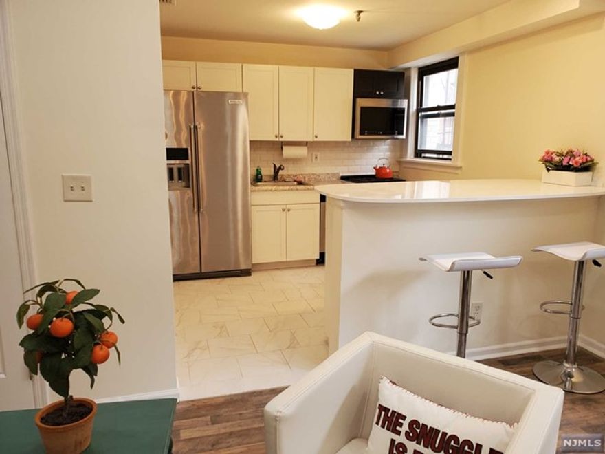 930 sqft of real estate heaven! Luxury NYC living in the best building of East Hill area of Englewood, 10 min drive to NYC for a fraction of NYC cost of rent! NYC bus across the street. Stunning fully renovated one bedroom (easily converted to 2-bedroom) apartment in a secure historic building in the heart of Downtown Shopping & Restaurant District, corners E. Palisade, across the street & a view of the Library and Renaissance Center. Features new state of art kitchen with stainless steel appliances & huge island, updated bathroom, large bedroom with 3 bright windows & antique fireplace, grand foyer with a wall of closets, central air, intercom, new floors, 9' ceilings, hi-hats with dimmers, 5 closets. Beautiful open hexagonal stairway lobby with a skylight. New laundry & storage. A 4-story garage is a block away. Ample street parking. Dogs & cats welcome! Steps to Bergen Performing Arts Center, yoga, hot yoga, NYSC, Shoprite, Englewood Hospital, & restaurants. Relative has NJRE.