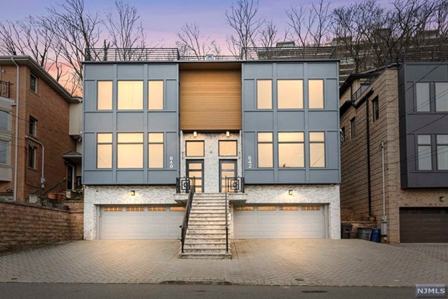 Experience luxury living in this newly constructed property boasting breathtaking views of NYC & the Hudson River. Situated in a highly sought-after location on Undercliff Ave. This 7-year-old home features top-of-the-line upgrades, high-end materials, crown moldings, high ceilings, pristine hardwood floors, 2 fireplaces, Sonos stereo & security system. 1st floor open-concept layout w/ spacious living room, dining area, powder room & chef's kitchen equipped w/ premium appliances. 2nd floor, 2 beds, full bath, plus a primary suite including a soaking tub, radiant floors & a steam shower. 3rd floor, entertainment space w/ a wet bar, 4th bed, full bath, front deck w/ spectacular NYC views & gas line for grilling, plus backyard w/ paver patio. Ground level, 2-car garage, rec room, storage & half bath. This meticulously crafted property spans 4 levels, each exuding sophistication & comfort. Close to Veterans Field Park, restaurants, shops, NYC bus, Edgewater Ferry & free shuttle.