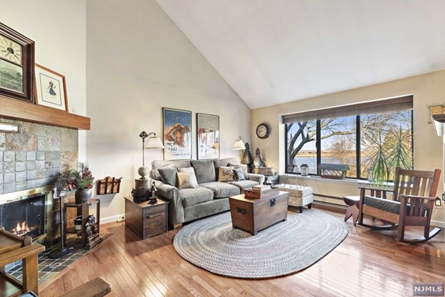 Absolutely stunning 2BR/2.5BTh, duplex townhome perched on the banks of the Hackensack River. This Falmouth layout features 1450SF of living space and direct river views from a sunken living room w/cathedral ceilings and wood burning fireplace. Hardwood floors run throughout the entire unit. Updated kitchen w/stainless steel appliances, Corian countertops and large island. Venture upstairs to your master suite with master bath along w/additional guest bedroom and full bath off hallway. Tankless water heater and central AC/forced hot air. Amenity rich complex w/ 24hr security, club house, pool, tennis & basketball courts, marina and NYC transportation. Complex has an onsite cafe and is frequented by innovative food trucks. **PHOTOS COMING SOON