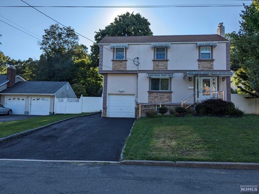 UPDATED COLONIAL. HUGE MODERN EAT-IN KITCHEN, ATTACHED GARAGE ENTRY, SLIDER TO 12X12 DECK, FULLY ENCLOSED PRIVACY BACKYARD FENCING, DINING ROOM AND LIVING ROOM WITH FIRE PLACE. MASTER EN SUITE WITH SHOWER (LARGE WALK-IN CLOSET AND ATTIC STORAGE), 3 LARGE BEDROOMS, 1 FULL BATHROOM, AND SPACIOUS FAMILY/REC ROOM ALL LOCATED ON THE 2ND LEVEL. 2 ZONE AIR CONDITION AND HEATING. FINISHED BASEMENT AND LAUNDRY MACHINES ON PEDESTALS. MANY LOVELY FEATURES IN THE HOME, MUST EXPERIENCE IN PERSON. CENTRALLY LOCATED TO ALL SCHOOLS FROM ELEMENTARY, MIDDLE SCHOOL TO HIGH SCHOOL, TRANSPORTATION TO NYC, DOWNTOWN TENAFLY. LAWN-CARE INCLUDED. OWNER HOLDS NJ REAL ESTATE LICENSE.