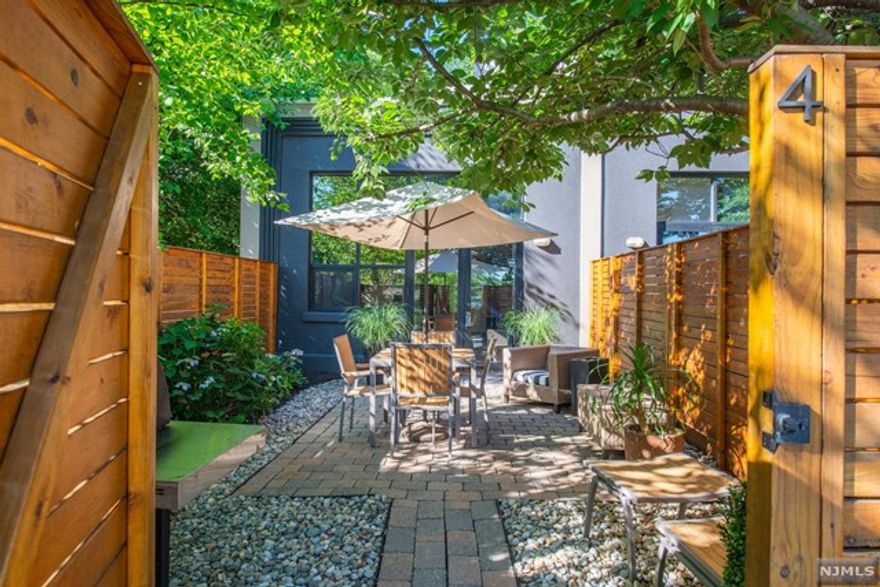 Industrial Loft condo for rent with a bespoke design appeal in a private location. Down a long driveway, in the heart of Downtown Montclair, you will find an intimate 8-unit complex (pet friendly) with convenient parking, and direct unit access. A private courtyard behind a wood privacy fence greets you after a long day at work, or a quick jaunt to Walnut Street. The details are endless - concrete floors with wood inlay, floor to ceiling windows, huge fireplace and mantle, plus open sightlines throughout. The first floor offers the open kitchen with pantry storage, full size laundry machines, a first floor office/den and a full bathroom. Upstairs you have a lofted suite with bedroom, walk-in closet and full bathroom with treetop views. Unit comes with 2 parking spaces. Pet Friendly. Tenant controlled HVAC. November 1st lease start with flexibility. This is the one!