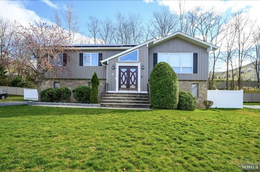 Nestled on a quiet suburban neighborhood, top-rated Blue Ribbon Schools, easy commute to NYC by bus. Completely renovated single family with 4Bed 2.5Bath. The ground level entry foyer accesses the family room with sliders that open to a rear deck, powder room, laundry room and direct access from the two-car attached garage and one bedroom. Main level features bright open concept large living room with picture window and dining room with vaulted ceilings. Three bedrooms with new hardwood floors with a full bath and tub shower that serves two of rooms, while the primary bedroom has its own private bath with shower. Attractive mechanical systems include central air conditioning and two zone baseboard heating. Completing this wonderful home is a spacious deck overlooking a large, flat & fully fenced backyard with kids' playground. Solar system saves you monthly bill (solar pays by landlord), lawn care, pest control also offered by landlord. Smart home system, wine fridge included.