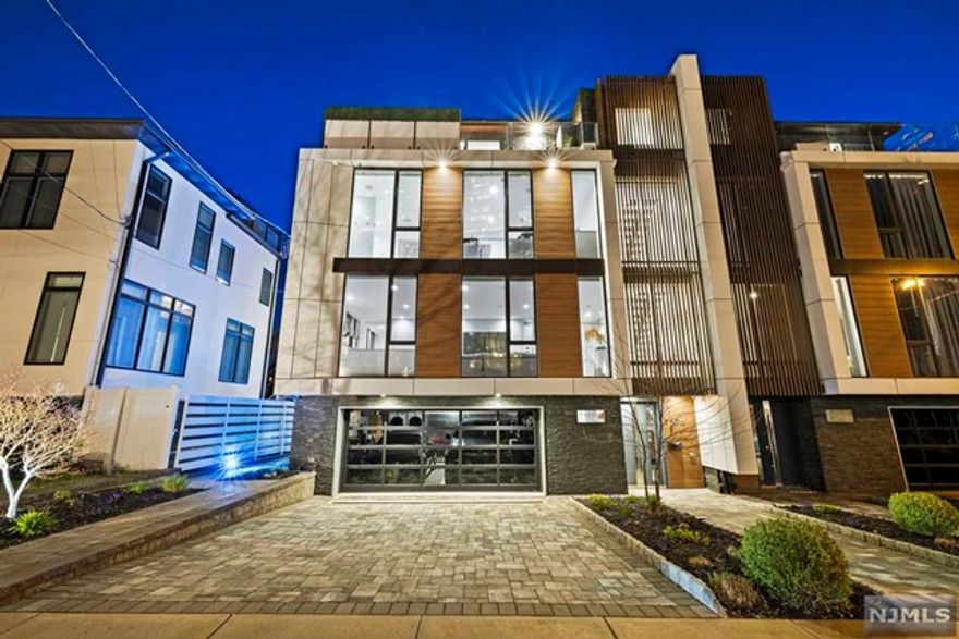 Chic SOHO hotel style meets Edgewater in this exquisite duplex. Built by a NYC builder, this sexy contemporary duplex is unlike any others around. The airy feel of a 34"ft wide interior adorned w/floor to ceiling windows and white accents throughout. Dramatic white natural stone bricks line the walls of the entire floating staircase. Highest grade everything from the wood flooring & appliances to the new boiler. No expense was spared by both the builder and this original owner. Recent upgrades from top to bottom include outfitting for commercial Restaurant level cooking yet keeping to the integrity of residential living. Beautiful white quartz Counter tops w/underlighting in both kitchens: one main kitchen below and a Summer kitchen above for the spectacular "sky lounge", w/a wrap around terrace, complete w/a hedge panel' privacy wall. Enjoy breathtaking views of the Hudson and Manhattan while entertaining or relaxing in the incredible atmosphere unique to this home.