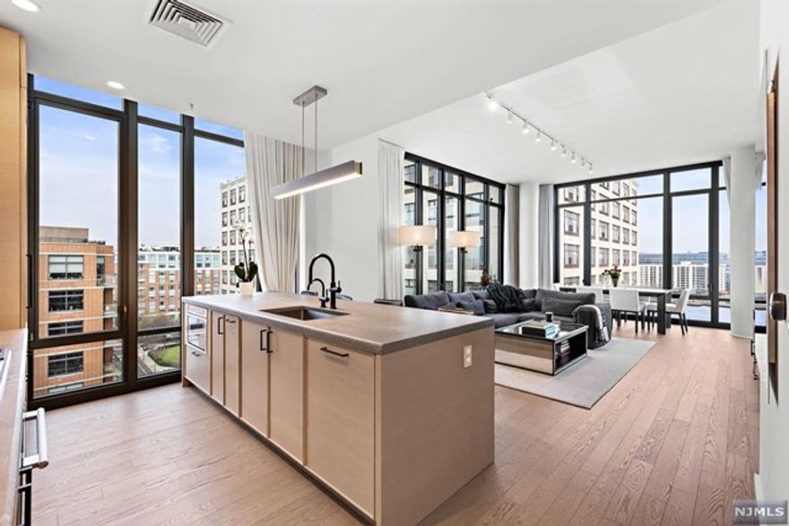 Enjoy the view from the top at 1425 Hudson St Penthouse 5, a sanctuary of luxury and elegance in Hoboken's vibrant waterfront north community. This top-floor residence stretches over 1421 sqft, featuring 2 bedrooms and 2.5 bathrooms. The moment you enter, you are captivated by the high ceilings and the flood of natural light pouring in through the oversized windows. These windows illuminate every inch of the unit and also frame the panoramic views of the cityscape and the NYC skyline. This penthouse features an open-concept layout and a gourmet kitchen that stands out with its designer appliances, ample counter space, and stylish cabinetry. Situated in the most sought-after location in Hoboken, PH5 offers unparalleled access to NYC, with multiple transit options at your doorstep. Don't miss the chance to experience life at the top, where every detail reflects meticulous craftsmanship and an unmatched standard of living.