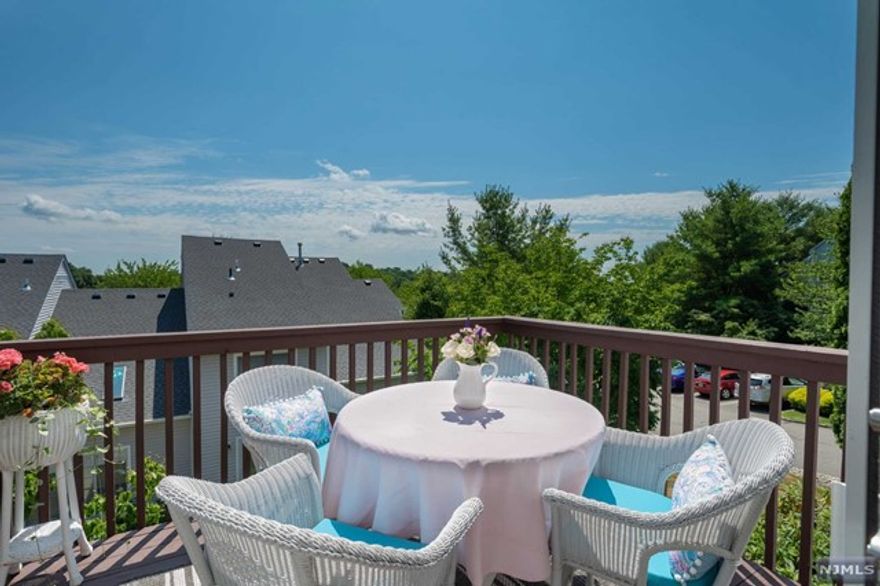 Gorgeous sun filled end unit with beautiful views from the deck and from the wall of oversized windows in the living area! Glistening hardwood floors throughout, wood moldings, gas fireplace, updated bathrooms and kitchen. The chef's eat-in kitchen boasts plenty of custom cabinetry, TWO separate ovens, granite, a wide breakfast counter that seats four and is open to the living area and formal dining room. A renovated powder room, laundry facilities and access to the two-car garage complement this floor. The sweeping open staircase leads to an elegant primary bedroom with two large walk-in closets, a relaxing sitting area and a spa-like primary bathroom. The other two well-sized bedrooms on this floor each have walk-in closets and double windows. The fabulous finished walk out basement offers a wet bar, dishwasher, microwave, crown moldings and a spacious powder room. Take a dip in the pool, or go for a hike in the nearby Tourne County Park.