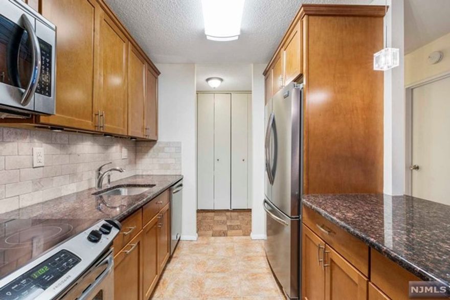 Spacious 2 bedroom 2 bath in the Parker Imperial featuring a beautifully upgraded open concept kitchen with stainless steel appliances, granite counters and wood cabinets, a large living room with large balcony overlooking pool and adjacent 167 acre park w lake, a large formal dining room, an enormous master suite with a walk--in closet, a full bath and vanity dressing area, a large second bedroom with large closet and second bathroom in hallway. Lots of closets and hardwood floors throughout. Condo was recently painted white. Pics are from previous occupant. The Parker Imperial features 24/7 doorman, 24/7 garage attendant, 4 new hi speed elevators, outdoor heated pool w sun deck, on-site fitness center w his/hers showers/saunas, a laundry room on every floor, free tennis in adjacent 167 acre park w lake, on-site management. Minutes to Manhattan by bus or ferry. Transportation to NYC, Hoboken, Jersey City @ door. Shopping and great restaurants nearby. Price Negotiable! Pets ok!