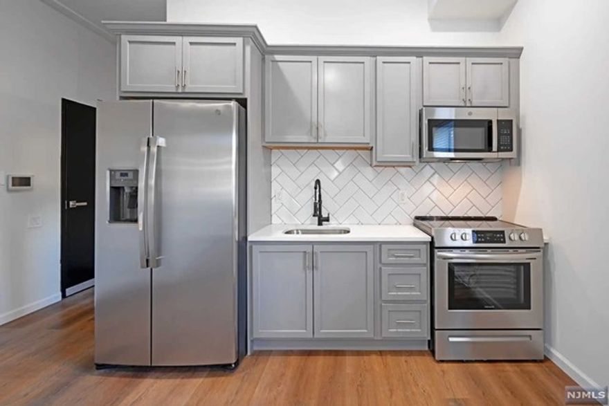 Welcome home to a Spectacular newer construction Studio unit. Plenty of natural light in all rooms will be sure to impress. This unit features an updated kitchen with shaker wood cabinets, stainless steel appliances, quartz counter tops and hard wood floors flowing throughout. Open concept kitchen, living room Bedroom combo will make it easy to entertain guests. Plenty of closets, In unit laundry hookups & touch screen intercom system. Heated and Cooling wall units provided. This first floor unit has elevator access if needed. Bus transportation, Train and Park just a block away, municipal parking close by. One Month Broker fee. Don't miss this Opportunity to occupy this beautiful new unit.