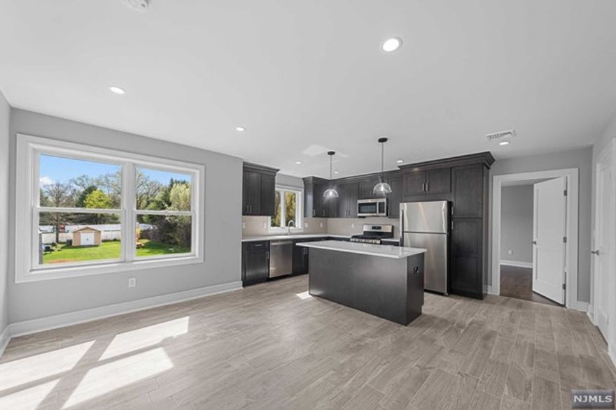 STUNNING! Completely Renovated 2 Family Home in the heart of PARAMUS! West Side Location. Unit 2 is UPSTAIRS unit. Features 3 bedrooms, 2 full bathrooms, and plenty of living space. Everything is BRAND NEW! Large Living room is open to Gourmet Kitchen with center island, plenty of Cabinet Space, Quartz Countertops, and SS appliances. Spacious Bedrooms - Primary Bedroom features en-suite Primary Bathroom. Gleaming Hardwood Floors, W/D IN UNIT, and tankless hot water heater! 1 Car Garage Parking & 1 Car Parking Space. Credit Check, Proof of Income, and 1 month Broker Fee is required. Utilities Responsibility of Tenant. LL covers Landscaping and Snow Removal. Sorry, no backyard access.