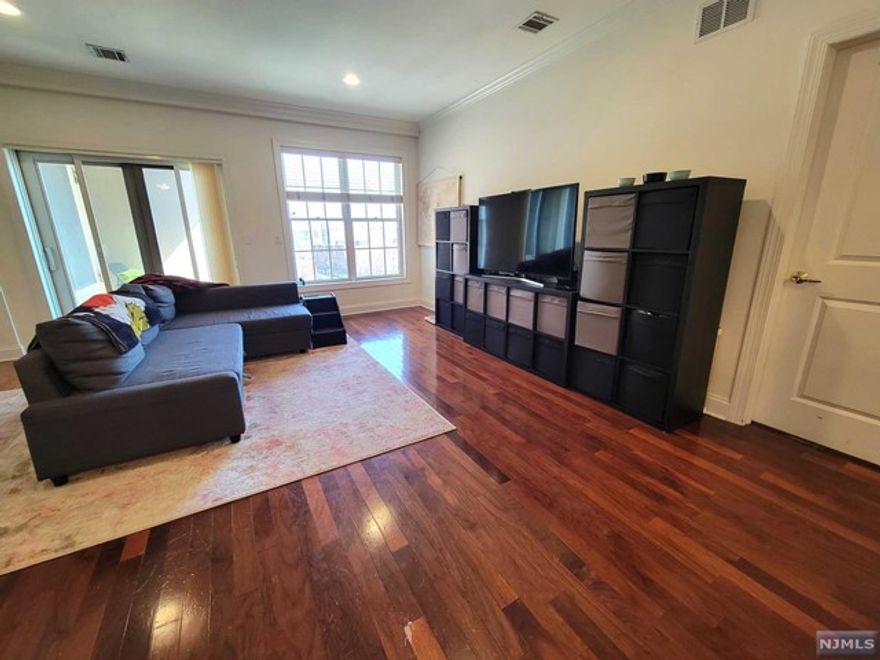 Very Large and Spacious, Top Floor unit with 1590 square feet is ready to be Your New Home! Open Concept Living with Large Granite Island, Stainless Steel Appliances, Recessed Lighting, Central Air, Crown Molding and Full-size Washer/Dryer in unit! Private Balcony plus Tons of Natural Light gleaming in through your Large Pella Windows w/Hunter Douglas Blinds. Primary Suite includes Walk-in Closet and Bath with stand-up shower. Second Bedroom also has Walk-in Closet too! Third Bedroom/Den/Office is almost 11x13'. Newest Condo Building in Hackensack! Conveniently situated within walking distance to restaurants, shopping, Essex St. Train Station and NYC Bus Stop is right across the street. Maintenance includes Two Indoor Parking Spaces and Newly Equipped Gym. Plus available Visitors Parking. Pet Friendly Building! Investors welcome, can immediately rent out. Building is not FHA approved. Highest and Best due Wed 4/12 @ 6pm