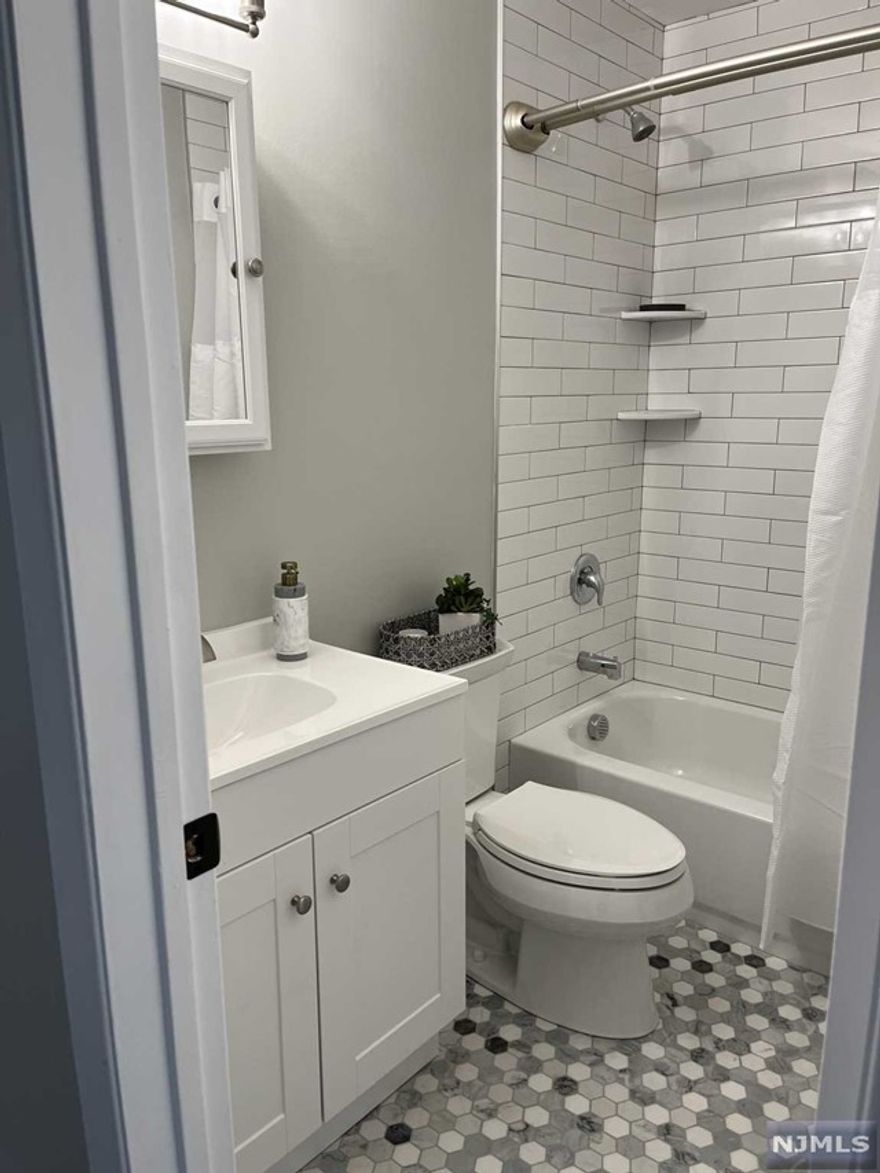 Renovated and Location! Just unpack in this beautiful 2nd floor corner unit w/tons of natural light conveniently located near NYC transportation. Featuring one floor living with spacious open floor plan with Living Rm/Dining Rm, Galley Kitchen with granite counter tops. Highlights include oversized primary bedroom with generous double closets including closet organizer. Large Second bedroom features oversized closet with closet organizer. Modern bath with subway tile tub/shower. All new laminate wood flooring throughout. Complete with your own PRIVATE Washer/Dryer in your own private 10 x 10 Storage Room. Tons of closets and storage. Assigned parking steps from door. One additional space can be rented.