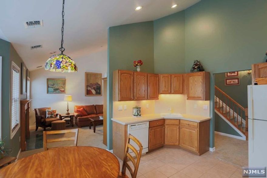 Welcome Home to this 1 floor living Cambridge Heights unit with 2 bath, 2 bed, laundry, fireplace, cathedral ceiling, fire suppression & security systems, Heat/AC 3yrs young. Great unit location w/ abundant sunlight showcases fine finishes including loft w/ bookcase, nook, desk & drawers. Extra Large-EIK supplied with lots of cabinet space & panoramic view. The 1 car garage equipped with a water faucet & lots of built-in custom storage leading to a driveway fit for 2 more cars. Cambridge Heights location and amenities speak for themselves including pool, gym, playground, tennis, club house, lower Manhattan view, NYC bus, open spaces, walk path, & dog run.