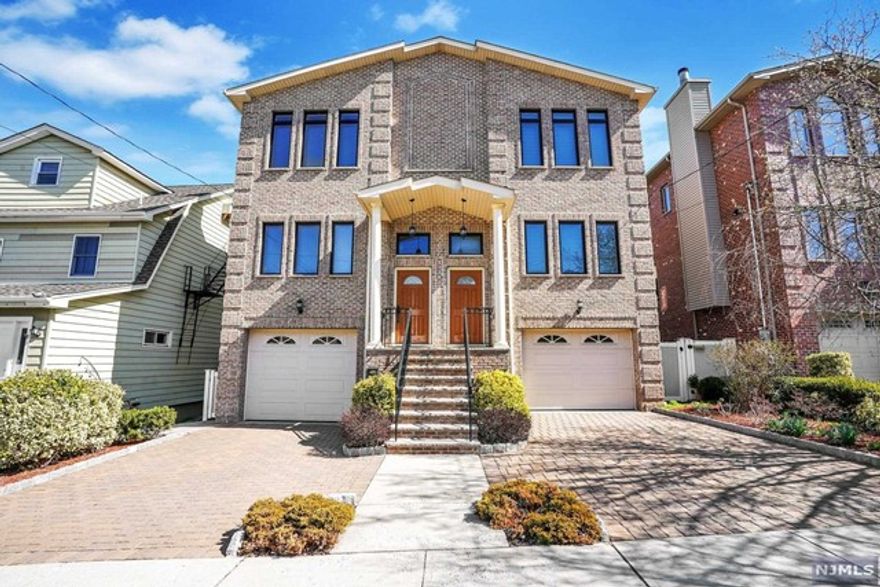 Welcome to this centrally located and meticulously cared for 3 bedroom, 2 full/ 2 half bath home. Pride of home ownership can be seen all throughout the home. Open floor plan on the first floor is accented by the modern columns positioned in between the living room and dining room. Mini bar area and breakfast area in the corner of the kitchen leads to your private outdoor deck. Iron wrought railings decorate the stairs leading to the ground and 2nd floor. Expansive 10 ft ceiling on the ground level make for a great and open family room/recreation area with a walk-out sliding door to your private fenced in backyard. Very large 1 car garage with plenty of storage space. The master bedroom ensuite, two bedrooms, 2nd full bath, and the laundry area with washer/dryer on pedestals are on the top floor. Close to NYC transportation, school, and shopping. Not to be missed!!