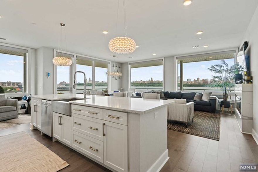 Discover urban sophistication at the Glasshouse in this 3-bed/2.5-bath residence with 1964sqft of living space & a 1001sqft balcony w/ stunning Hudson River & NYC views. The open-plan kitchen, living, and dining areas feature oversized windows with automatic shades, highlighting the Manhattan skyline & natural light. The chef's kitchen includes Caesarstone countertops, Subzero, Wolf, & Bosch appliances, & a large island. Three spacious bedrooms offer large windows, ample closet space, & private balcony access and bathrooms that are marble-encased providing a spa-like retreat w/high-end fixtures. The large private deck w/rust-resistant flooring is perfect for relaxing/entertaining. Home includes W/D room, remote shades for every window, 2 indoor & 1 outside parking, & 2 storage units. Glasshouse amenities include a fitness center, rooftop terrace w/panoramic views, & 24-hour concierge service. Prime location with easy access to transportation, dining, shopping, and entertainment.