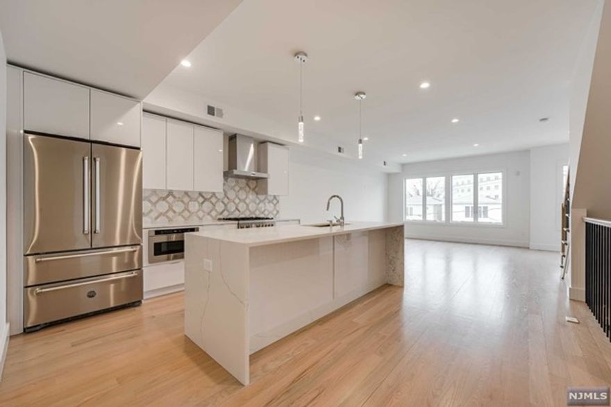 Welcome to this luxurious 1300+ sq foot condo in the highly sought after Jersey City Heights! This 3 bed 2 bath condo is all new construction and features a beautiful and serene private rooftop patio that is fully equipped with gas, hot and cold water, Trex decking and beautiful NYC views! The custom chefâ€™s kitchen is complete with Bertazzoni appliances, quartz countertops with waterfall Moen faucet, European style frame less cabinets and 4" solid hardwood flooring. The open floor plan in the kitchen and bright spacious living room allow for great entertainment space. The beautifully updated bathrooms boast frameless shower doors and rain shower heads as well as a double sink vanity. This unit features a modern design throughout, energy efficient full spray foam insulation, separate private entrance, additional private storage and parking spot in the attached garage! Plus, a central Vacuum system, Andersen windows, Rheem HVAC, sound dampening rubber member between floors.