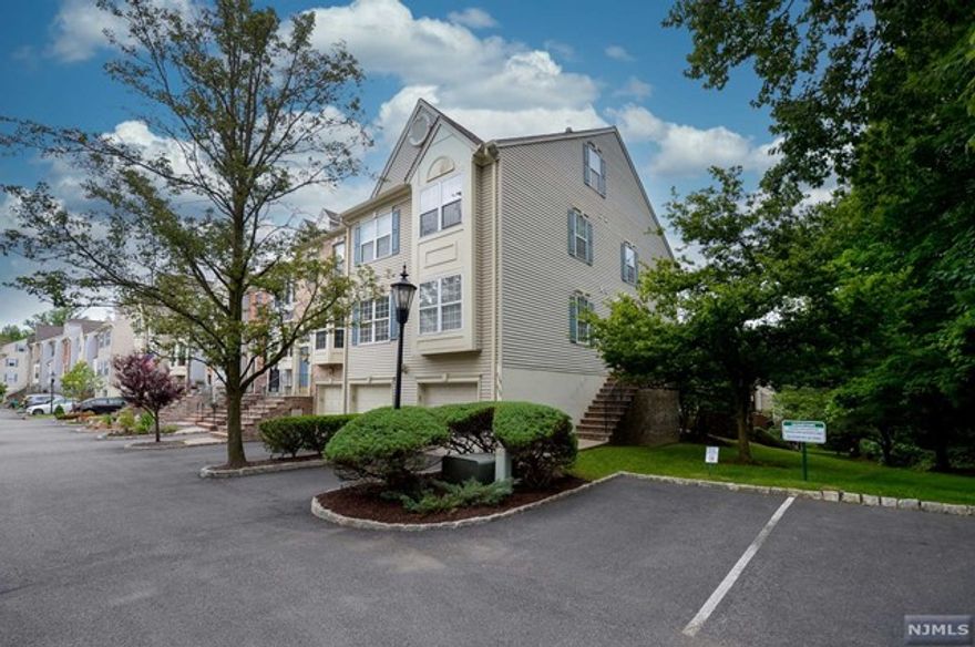 Located in the desirable Georgetown section of Cambridge Heights, this private corner town-home has garage access and beautiful updates! The entry foyer leads to an open Living Room with a wood burning fireplace, beautiful hardwood floors and access to a serene outdoor deck. The updated kitchen is equipped with stainless steel appliances, granite counters and adjoins the dining room with bay windows that let in plenty of natural light. The first floor continues to the primary bedroom with a large walk-in closet, and a full bathroom. Laundry, a second full bathroom, and a second bedroom complete the first floor. The ground level features a spacious Family Room with access to the 1 car garage and an outdoor patio. Georgetown homeowners have unique access to the designated pool, and guest parking. Close to NJ-17 Ramsey Train Station serviced by the Main Line and Bergen County Line, along with Port Jervis Line. Sought after community in Ramsey, this is truly a house to call home.