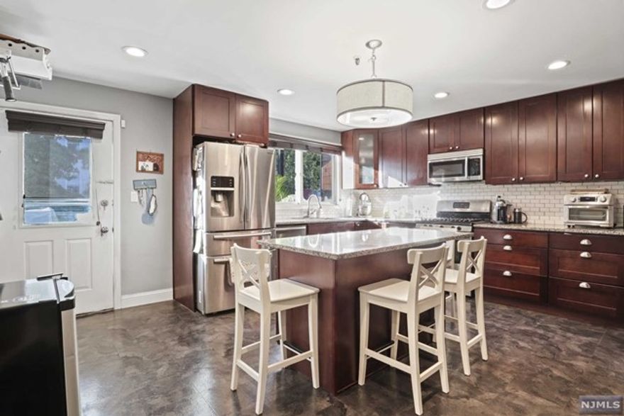 Check out this two bedroom condo with beautiful fixes & ample square footage! This unit features a large living room flooding with natural light. Beautifully designed bathrooms, a large kitchen with granite countertops, two big bedrooms, one with its own bathroom and an exposed brick fireplace that brings everything together. A separate exit from the kitchen to the shared backyard where you can start your own garden and grill with your friends! The wide fire escape in the back creates a personal terrace vibe! Lots of closet space, W&D In-Unit, Hot Water Heater & HVAC Condenser both One Yr Old, Roof Replaced Summer 2022. Seven Minute walk to the Congress St. Light Rail Station (Two stops to Hoboken or Newport, Four stops to Exchange Place for easy commutes to NY). Bus stop down the block - direct line to Port Authority. 13 Minute Walk to Shoprite. Please inquire for a Matterport link!