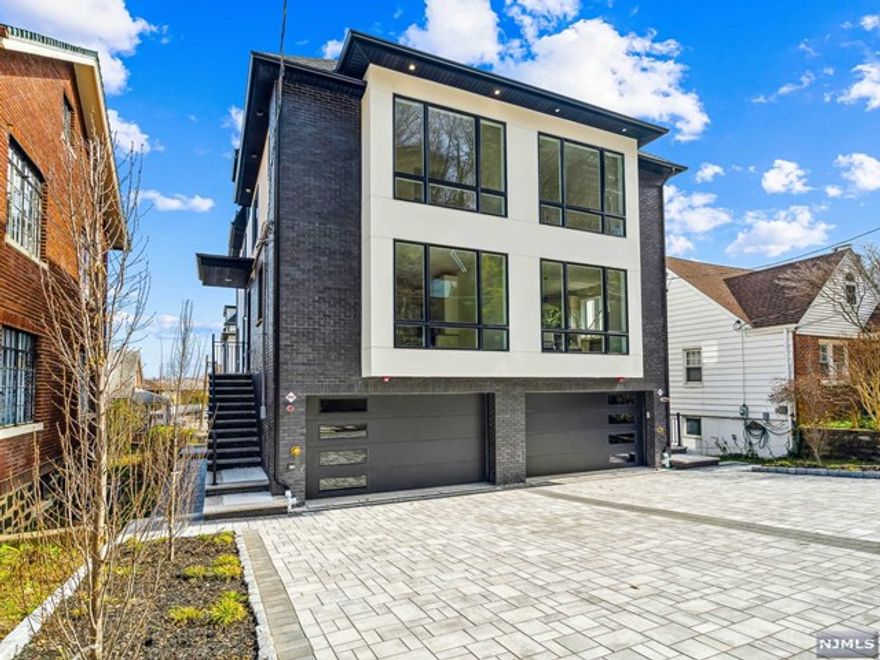 THIS CONTEMPORARY 4-LEVEL BRAND NEW CONSTRUCTION TOWNHOME FEATURES 3 BEDROOMS, 3 FULL BATHS, AND 2 HALF BATHS. UPON ENTERING, YOU'RE GREETED BY AN OPEN-CONCEPT LIVING AND DINING AREA. THE KITCHEN BOASTS PREMIUM APPLIANCES, QUARTZ COUNTERTOPS, AND CUSTOM CABINETRY. WITH HIGH CEILINGS ON ALL LEVELS AND AMPLE WINDOWS, NATURAL LIGHT FLOODS THE HOME, ACCENTUATING ITS EXQUISITE DESIGN. COZY UP BY THE GAS FIREPLACE IN THE LIVING ROOM FOR RELAXING EVENINGS. A FLOATING STAIRCASE CONNECTS ALL LEVELS, CULMINATING IN THE FOURTH-FLOOR ENTERTAINMENT ROOM WITH A WET BAR. ENJOY STUNNING VIEWS OF THE NYC SKYLINE FROM THE COMFORT OF YOUR PRIMARY BEDROOM OR ROOFTOP TERRACE. ADDITIONAL FEATURES INCLUDE MULTI-ZONE AC/HEAT, ANDERSON WINDOWS, LED LIGHTING, AND A CENTRAL VACUUM SYSTEM. THE GROUND FLOOR HOSTS A BONUSROOM IDEAL FOR HOBBIES, FITNESS, OR SERVING AS A GUEST SUITE.