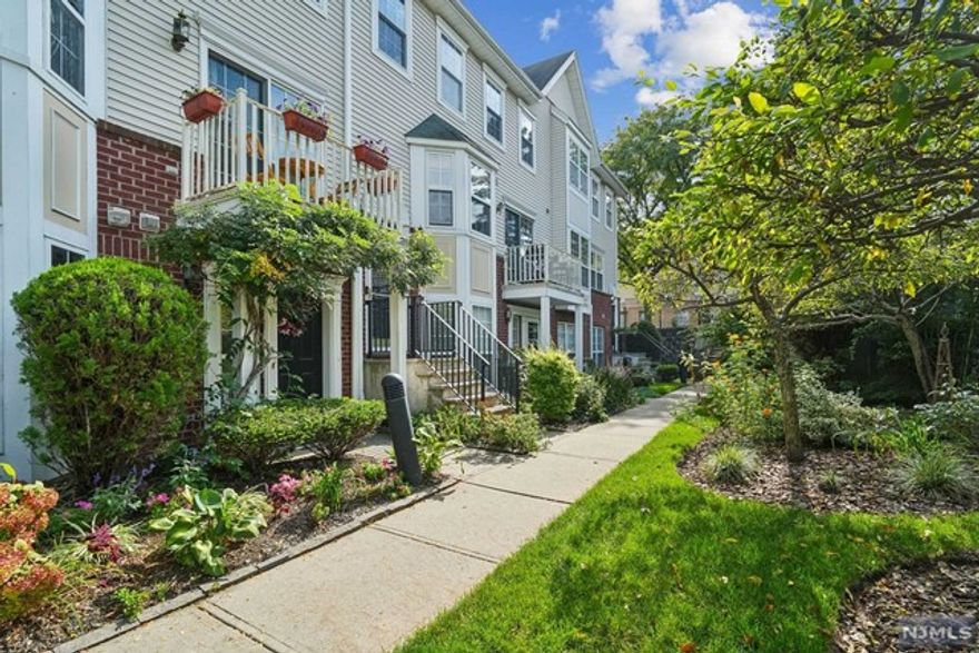 Perfect for Commuters! Discover this sun-drenched 2-bedroom, 2.1-bath townhouse in a beautifully landscaped complex in downtown Montclair just steps from the NJ Transit Bay St Station for a seamless NYC commute. The main level features an open floor plan with gleaming hardwood floors, a spacious living room, dining area, and a guest powder room. The renovated kitchen boasts stainless steel appliances, quartz countertops, and ample custom white cabinetry, plus a private balcony. Upstairs, a hallway full bath and 2 spacious bedrooms, including a primary suite with an en-suite bath and generous closet space. Enjoy the convenience of in-unit laundry and a community-oriented living experience. Immerse yourself in Montclair lifestyle with easy access to local restaurants, shops, farmer's market, parks, and a highly sought-after magnet school district. Two assigned parking spots! Experience the best of Montclair living while maintaining an easy commute to NYC. This unit defines location!