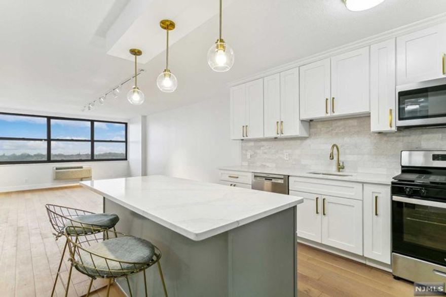 Welcome to luxurious living at the prestigious Galaxy Towers! Perched on the 36th floor, this stunning 3-bedroom, 2.5l bathroom condo has undergone a complete renovation, offering breathtaking panoramic views of the iconic NYC skyline and Hudson River. The ultra-modern eat-in kitchen serves as the heart of the home, boasting marble counters, stainless steel appliances, and a stylish island with bar seating. Hardwood flooring flows effortlessly throughout the condo, leading you to the spacious living room, bedrooms, 1/2 bath and hallway bathroom. The highlight is the expansive primary bedroom, boasting an en suite bathroom adorned with opulent marble tile and sophisticated gold hardware. As a resident of Galaxy Towers, you'll enjoy unparalleled access to a wealth of amenities, including both indoor & outdoor pools, fitness center, shopping, a rec room, and much more. Experience the epitome of luxury living in this exclusive community, where every comfort and convenience awaits.