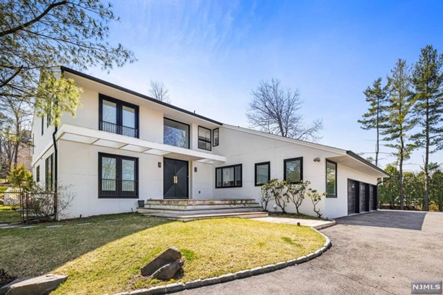 PRIME RENTAL set high on the Alpine / Cresskill border in one of Bergen County's most sought after neighborhoods. Nearly 6,000 sq feet. Renovated eat in kitchen with space for grand entertaining. Hardwood floors throughout. Large west facing windows showcase sunset views. Bright open floor plan with large rooms looking over deck and pool. Upper level primary suite with private balcony. Three additional bedroom suites. Lower level bedroom and full bath, family room, office / library. . Three car garage, mudroom, minutes from GWB. MUST SEE.