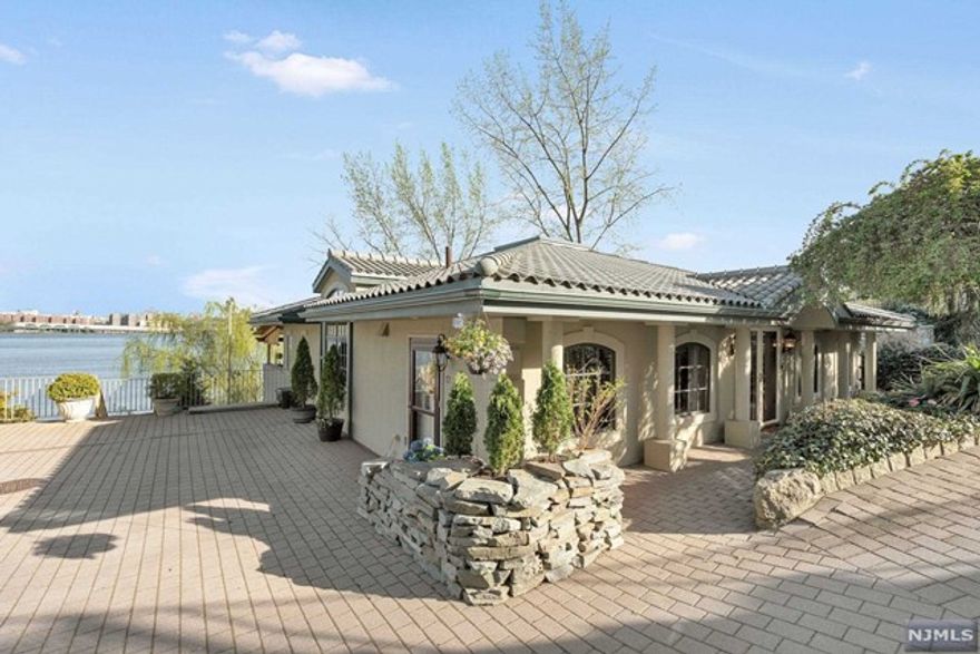 Welcome Home! This custom built river front home has a secluded beach, unobstructed panoramic views of NYC & the GWB. Located in the prestigious & private Edgewater Colony this home features 4 bedroom, 3.5 bathrooms, high ceilings, radiant heated floors and other amenities spread throughout. Upon entering into the entry foyer on the main level you're met by a grand salon with exposed heavy timber natural framing, custom kitchen, large formal dining room, living room with fireplace, guest bathroom, game parlor and media room. French custom doors lead to the covered balcony with outdoor kitchen and river/NYC views. The second level features a large principle suite w/ travertine heated floors, a large custom walk in closet for two, sunken jetted tub with separate shower and duel sinks, floor to ceiling windows and french doors lead to another balcony and more river/ NYC views. A second ensuite bedroom, two additional bedrooms, bathroom and utility rooms complete this home.