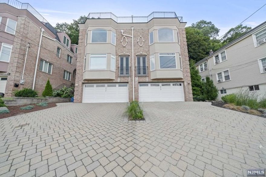 LOCATED IN THE DESIRABLE NORTH END OF EDGEWATER THIS AMAZING DUPLEX HAS OUTSTANDING UPGRADES INCLUDING, SOLID MAPLE FLOORING, ELECTRIC RADIANT HEATED KITCHEN FLOOR, GAS FPL IN LR, CROWN MOULDING WITH COVE LIGHTING IN LR, GOURMET KITCHEN WITH VIKING APPLIANCES, MARBLE CENTER ISLAND WITH VEGGIE SINK AND BUILT-IN MICROWAVE, STAINLESS FARMERS SINK, GLASS BACKSPLASH AND STONE COUNTERS, LARGE PANTRY & FRENCH DOORS LEADING TO BACK PATIO. REAR PROPERTY HAS ACCESS TO INTERSTATE PARK. 2ND FLR OFFERS MASTER BEDROOM W/2CLOSETS, MBTH W/FREE STANDING TUB AND MULTIJETTED STEAM SHOWER W/FOG FREE 5/8 INCH SEAMLESS GLASS SURROUND. ADDITIONAL 2 BRS, LAUNDRY, FULL MAIN BATH SS OVER TUB. 3RD FLR LARGE FAMILY RM WITH WET BAR, POWDER ROOM, ENTRY TO ROOF TOP DECK & GAS GRILL. SPECTACULAR VIEWS OF BOTH NYC & THE GW BRIDGE. GROUND LEVEL ACCESS HAS PRIVATE OFFICE, FULL BATH AND ENTRY TO 2 CAR GARAGE.