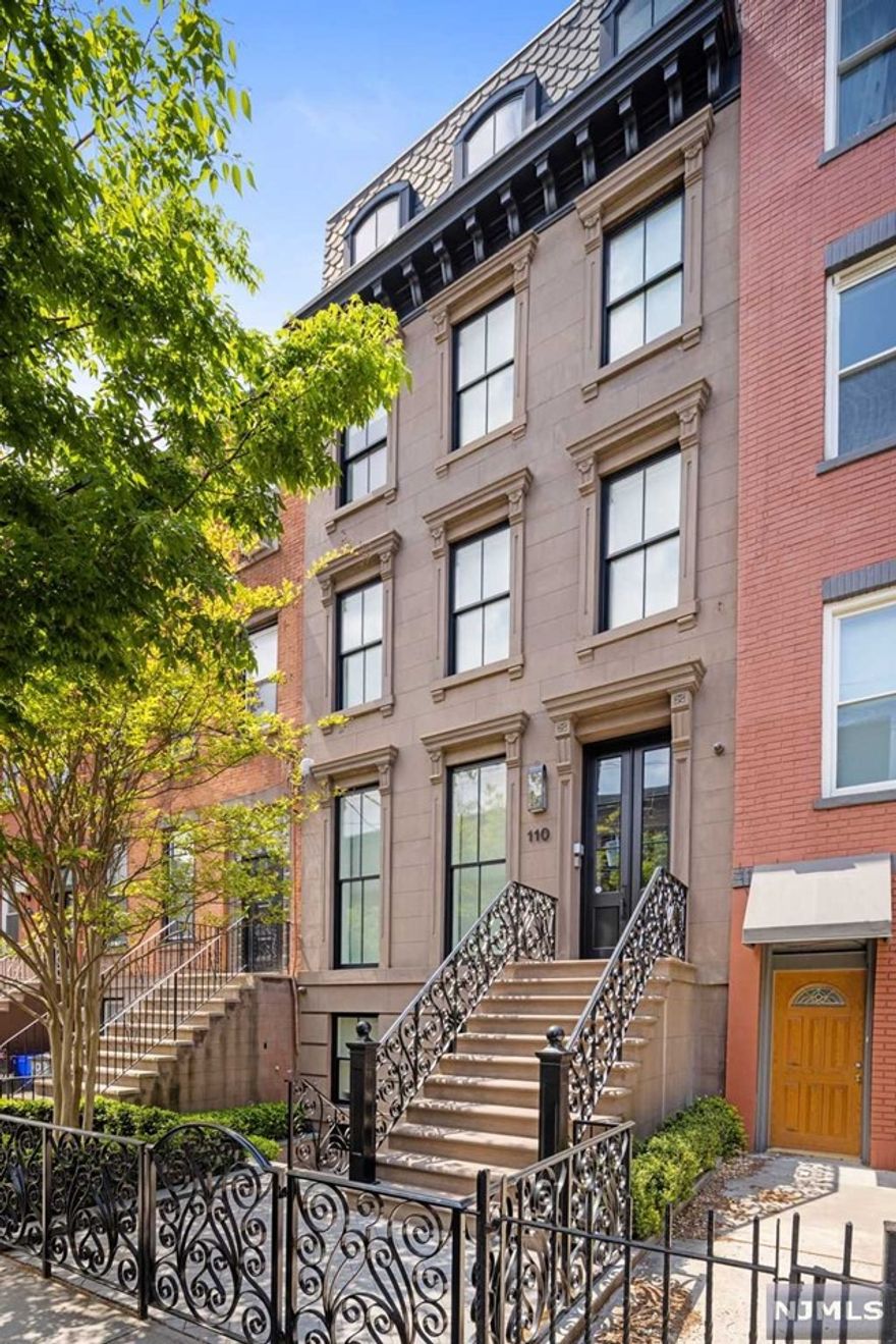 Rare downtown Hoboken duplex brownstone condominium by HRG Development. Completed in 2017 and inspired by design and craftsmanship, 110 Park Avenue is a seamless collective of historic architecture, luxury, comfort and location. This 2,830 SF four bedroom, three-and-one-half bath duplex with a large Ipe roof deck and a privately keyed elevator, is abundant with style and amenities. Wide-plank herringbone white oak floors, custom cabinetry, high ceilings, elegant millwork, oversized solid doors, and floor-to-ceiling windows are just a few of the many elements that tie together the ultimate townhouse condominium. The gourmet chef's kitchen has custom painted cabinetry with a built-in pantry and an integrated appliance garage, Quartz countertops over a large walnut island, a 6-burner 36' Wolf range, a Wolf microwave drawer and hood, a Sub-Zero refrigerator and a wine refrigerator. The main living area has floor-to-ceiling windows with motorized privacy shades, built-in bookcases...