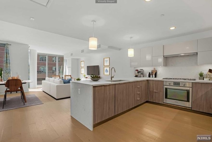 Live in pure modern elegance in the most premier & luxurious new construction building, Nine on The Hudson. Enter into this spacious 1,578sf, 2BR+Den/2BA open layout floor plan with SOUTHERN exposure & partial NYC views from the balcony. The kitchen includes Aspen quartz countertops, Pedini cabinets, Bosch appliances, & Thermador refrigerator. Move over to the expansive living & dining area, extending to the balcony. Further inside, large master ensuite with a custom WIC, generous size 2nd BR & large den. Wood flooring throughout, Bosch W/D, oversized windows, & 1-car garage parking. This beautifully designed luxury building features breathtaking views of NYC w/ 40,000sf of resort-style amenities: 24hr doorman, state-of-the-art fitness center, amenity deck with infinity swimming pool & BBQ area, rooftop deck with cabanas, lounging areas, pet grooming facility, children's playroom, virtual golf & quick commute to NYC via shuttle to/from the Ferry/bus that you will truly appreciate!