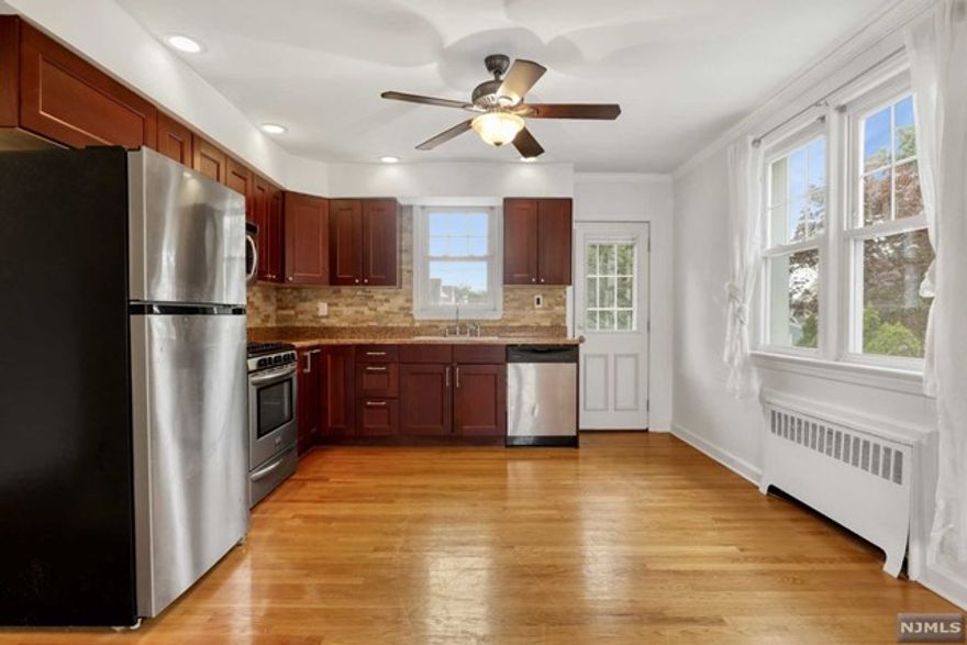 Spacious home with full finished basement for rent in a phenomenal location on a quiet suburban block! This home features an open and airy floor plan with hardwood floors through out, renovated kitchen with stainless steel appliances, granite countertops, large bedrooms and an abundance of natural sunlight. Kitchen leads to a private deck and large shared backyard. Still need more space? Enjoy the benefits of your own finished basement with two rooms for extra bedroom or kids play room. Shared laundry completes the package! Sorry no pets! Available 7/1!