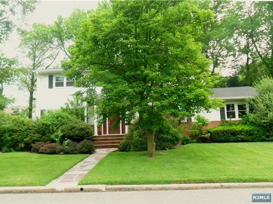Must see this bright & sunny Center Hall Colonial in the prestigious North Cliffs area of Englewood Cliffs. This approx. 2800 SQFT house offers 5 bedrooms and 2.1 bathrooms. Large entrance hall leads to a big living room, dining room & family room all beautifully detailed w/ moldings & paneling. The kitchen is large & bright w/ 2 skylights over the middle island, granite countertops & custom made cabinets & top stainless steel applcs. A bedrm/office, laundry & powder room complete the 1st floor. On the 2nd floor, there is a spacious master suite w/ 2 closets, 3 add'l bedrooms & an updated full bath. The full & finished basement for entertainment. Nice landscaping with sprinklers system. Hardwood floor thru-out. Plenty of parking.