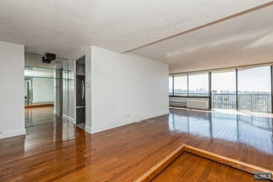 Panoramic views of the Hudson River and NYC skyline. This south-facing unit provides abundant natural light and ample space at approximately 1,292 s/f. Living room and dining areas are separated with a seamless transition with a raised floor. Sliding door to terrace. High quality built-ins, track lighting, and large closets.Modern kitchen with granite counter top and S/S appliances.Tandem parking space for 2 cars.Raised wooden floor for better river view. Maintenance includes all utilities, including electricity, heating, and water. Also, basic cable TV and internet, tennis court, swimming pool and 24-hour doorman. This high-rise building is pet-friendly. Very convenient area for shopping and schools. Easy commute to NYC by bus and water ferry.2 bedrooms,2 full bathrooms.