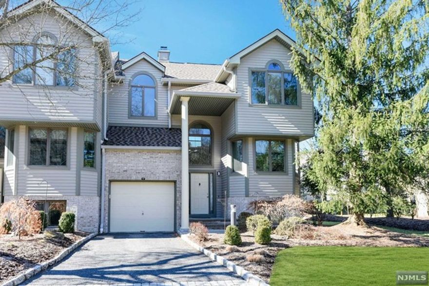 Light and bright corner unit in desirable Northwoods. First floor features large living room open to dining room with vaulted ceiling, gas burning fireplace, access to deck and eat in kitchen. Second floor has primary suite, additional bedroom, full bath and laundry area. Lower level boasts family room, office, large storage area. An additional bedroom and bathroom can be added to lower level. Northwoods offers pool, tennis court, play area, fitness room and social room. Norwood has highly rated school system and is close to Closter Plaza with high end shops and restaurants.