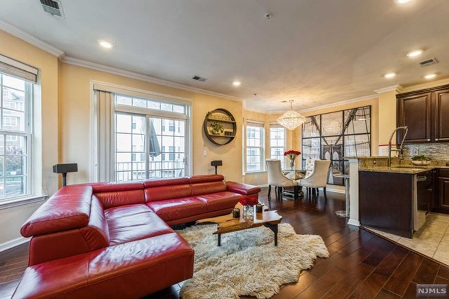 Enjoy life at the Signature Place at Garfield living in this Pristine 1700 sq ft end unit that awaits you. Located just 30 mins from NYC, this unit sits on a premium lot offering poolside views with a spacious layout with contemporary aesthetics including upgraded granite countertops, cabinets, lighting and wall trims throughout with a dual zoned heating/cooling system. The elegant kitchen is equipped with all stainless steel appliances including a new Whirlpool Stove and Refrigerator. Relish the natural light in the living/dining room that features hardwood flooring with a stunning floor to ceiling stone accent wall. The large master bedroom ensuite is built for relaxation and includes a jetted jacuzzi bathtub, a stand up shower and a large custom closet. The second bedroom includes a custom shoe closet alongside the den/potential 3rd bedroom. Residents enjoy many amenities including a clubhouse with a fitness center and an outdoor pool. Don't miss out on this rare gem!