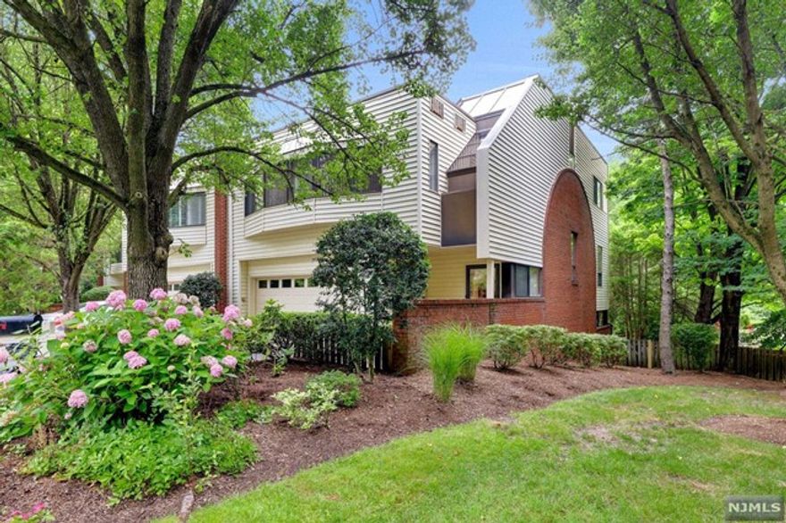 RARELY AVAILABLE! This Spacious Stunning Immaculate townhome is located in the Desirable and Private Hopper Ridge community. Very quiet neighborhood, yet walkable to the heart of downtown! This end-unit townhouse is deceiving from the outside! An abundance of light on every pristine level! Walk-out lower level has Family Rm with fireplace & a bath. Enjoy gorgeous sunrises on the private deck overlooking pretty duck ponds. Main Level is Huge with open concept LR/DR & spacious sunny eat-in Kitchen with atrium windows providing morning sun and beautiful views. 2 BR's on 2nd floor plus Laundry and Full Bath. The Private Primary BR on 3rd level is HUGE! Office or seating area welcomes you into the suite with a wall of windows overlooking back yard. 2-car garage accessed from Entry Hall level. Walk to downtown Ridgewood/train as well as Dunham Trail along the Ho-Ho-Kus Brook. HURRY, THIS ONE WILL NOT LAST!