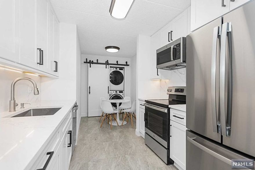 Contemporary and modern describes this 1 bed 1 full bath rental in the Avalon! Recently renovated with fresh details and upgrades, this unit cannot be missed! You'll be impressed with the bright and spacious upgraded kitchen featuring stainless appliances, bright white soft close cabinets, deep stainless sink and under cabinet lighting. A breakfast area provides space for morning coffee while a large closet with barn doors houses the new washer/dryer. The dining/living areas provide openness with plenty of space and a mounted TV with impressive backlighting is pre-wired for your use during your tenancy. The upgraded FB impresses with beautiful tiled floor and tub/shower, sharp floating vanity and lighted mirror. The BR offers ample space with 2 closets with organizers, while the deck with tiled wood flooring provides outdoor living space with southern views. Close to Hackensack University Hospital, Paramus/Hackensack shopping and NYC express bus nearby. Don't miss this one