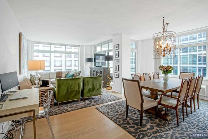 Welcome to Hoboken's luxury waterfront community at 1400 Hudson. This 1,292 Square foot 2 BD/2 BA is sure to please with an experience of luxury lifestyle that highlights incredible high end modern design. This home features state-of-the-art kitchen with custom, built-in, appliances and cabinetry, and Ceasar stone counters with a breakfast bar. Enjoy the luxury finishes with gleaming wide plank hardwood floors throughout, over-sized east facing windows that flood the open layout with natural sunlight and the large terrace. The primary en-suite has double vanities and a walk-in closet. Enjoy the oversized second bedroom and full bath, in home W/D and 1 indoor parking to complete the home. This community is fully accommodated with luxury amenities including 24hr concierge, 2 gyms, children play area, residents lounge, rooftop deck with BBQ and pool with NYC/Hudson River views and PATH shuttle.