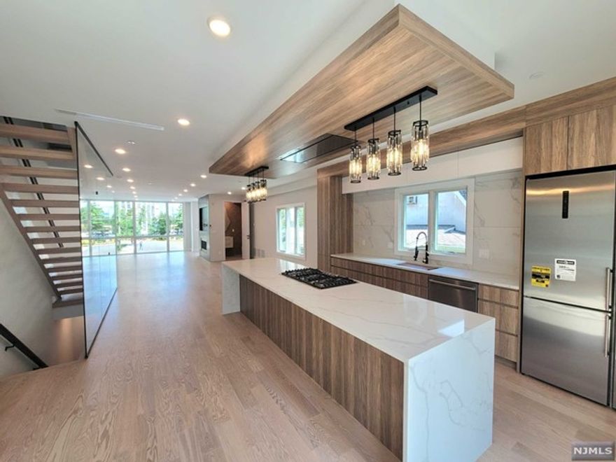 Experience unparalleled luxury in this Brand-New 3,300 sq. ft. Duplex situated on a tranquil dead-end street just east of Palisade Ave. Flaunting a captivating brick and stucco facade the interior seamlessly marries modern design with sophisticated elegance. Revel in the expansive open layout adorned with 9 ft ceilings, a gourmet kitchen enriched by high-end Italian materials, a dazzling 12 ft waterfall island, and professional appliances. An inviting gas fireplace with built-in shelves, LED-lit railings, and a top-floor entertainment room with wet bar epitomize upscale living. Coupled with Pella windows, smart home technology, a high-efficiency boiler, and instant hot water, this residence is the zenith of modern opulence. Stunning Contemporary Residence, Brand-New Modern Abode: Masterful Suites Rooftop Paradise: Modern living is at its best with smart house technology, Pella windows, and patio doors ensuring energy efficiency.