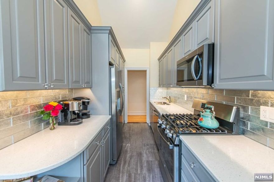 RARE FIND in Dwight Manor: Top/5th floor 2BR with cathedral ceiling! Looking for the perfect downtown Englewood lifestyle? Oh-so-close public transportation outside the building, and just blocks away from restaurants, shopping, BergenPAC theater, and MORE. Promised to be WOWed by the newly renovated kitchen, and living room with soaring ceiling height and eye-grabbing fireplace. Monthly maintenance includes heat, water/hot water, and gym. Unit sold with #26 parking spot. Laundry on-site.