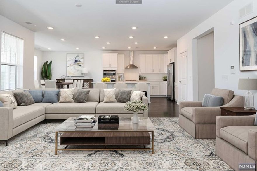 Enjoy NYC loft style living at The Venue at The American. Conveniently located right outside Morristown, this 55+ community offers a clubhouse, heated outdoor pool, and walking/jogging path with access to the Morris Plains Train Station. This Sycamore style unit boasts over 2000 sq ft of living space, open concept layout, primary bedroom with en suite and walk in closet, 2 additional bedrooms, and den/office space. The open concept kitchen is complete with GE stainless steel appliances, quartz countertops, shaker cabinets, and is steps away from your private balcony. Laundry room is conveniently located in unit and doubles as a mud room with its own entrance. This unit comes with Ring security system, private garage parking with interior access to building, and interior alcove for package delivery.