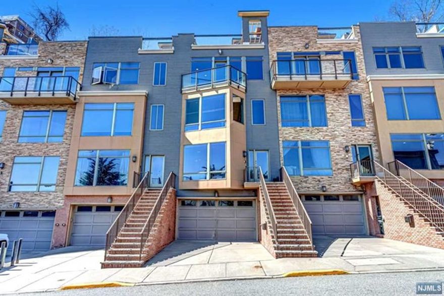 Welcome home to this lovely, sun-drenched 3575 sq ft townhouse with views of NYC and the Hudson River from every floor. Situated on a very private and quiet hillside street, 1 block away from NY-bound buses on River Road. Featuring 3 BR with oversized walk-in closets, 2.5 BA, bonus den on the ground floor, laundry room and 2-car attached garage. Highlights include a private elevator, great for accessing 4 stories of living space. Rooftop deck with outdoor fireplace, perfect for entertaining and relaxing. Custom energy-efficient dimming LED lights with dual mode (day and night ambiance lighting) all throughout the house. Chef's kitchen with Viking appliances and extra-large pantry. Large backyard oasis, perfect for barbecues, entertaining, and the occasional deer sighting. Solid, 3/4 inch cherrywood floors all throughout. Where luxury meets convenience, this house is 20-25 mins by bus to midtown Manhattan even during rush hour, and is a few minutes walk to shops, restaurants & more