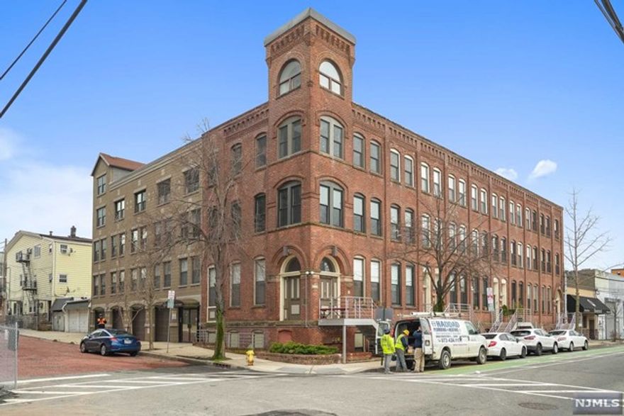 This sun-drenched Tower unit is truly a WOW! Located in the highly sought after Chocolate Factory Building, includes one covered parking space. Come see this move-in ready contemporary 1 bedroom, 1 bath apartment. Central AC/heat, 10ft+ ceilings, and tower which affords additional light to the unit. Wireless controlled shades, hardwood floors throughout, perfect for working from home or as a second home for commuters. European style washer inside the unit. High-end stainless steel appliances. So close to Newark Penn Station, Ferry Street restaurants, Blink Fitness, Starbucks, Prudential Center, downtown offices...15 minutes to Liberty Airport. Street parking available as well with parking pass available through the city. All that's missing is you.