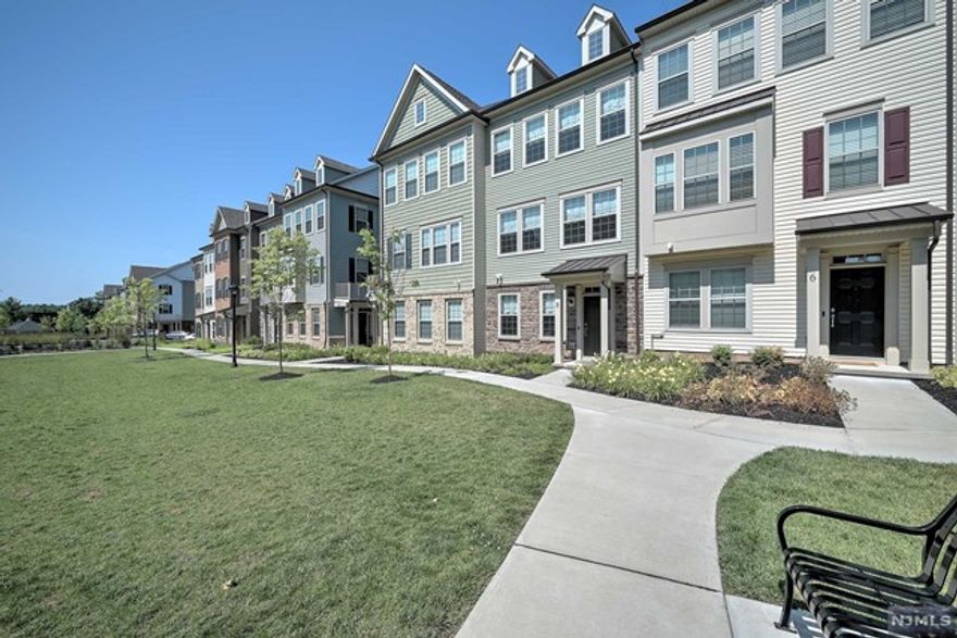 Enjoy luxury living with Amazing Upgrades & Courtyard Views! Over $90k in Luxury Enhancements! Gourmet kitchen features: Center Island w/Quartz counters & Breakfast Bar, Farm Sink, Double Pantry, Exhaust Hood, SS Appliances incl: 5-Burner Cooktop, Wall Oven & Microwave, Dishwasher & Refrigerator w/Flex Drawer. Hickory Hardwood flooring spans all 3 levels complemented by Crown Molding & exquisite lighting. All stairs feature oak rails & wrought iron spindles & plush carpet runners. Owner's Suite boasts high-end closet systems, tray ceiling & luxurious bath w/double sink vanity, Quartz countertop & Frameless Glass Shower w/Carrara Florentine Tile & Shower Seat. Bespoke window treatments add a final touch of elegance to every room. Flex Room suitable for BR, Office, Gym. Livingston is renowned for its top-rated schools & short commute to NYC, Newark Airport & Morristown. This townhome offers the perfect blend of elegance, convenience & community with 2 car garage & VERY low HOA fee!