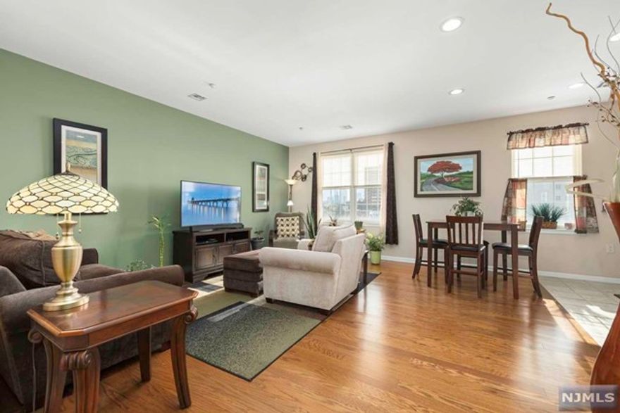 Welcome home to this updated Jersey heights unit in an elevator building. Full bathroom on main floor, two bedrooms & one bathroom upstairs. Recessed lighting on main floor & an abundance of window light throughout showcasing the immaculate condition. One garage parking space, gym, & laundry room are included! Near by the light rail station. New York City bus stop right out front granting NYC access in just minutes