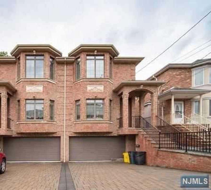 Location, Location, Location!!! Close to Broad Ave. Very well maintained over-sized duplex, graciously finished living space filled with abundant natural light and open lay-out, hardwood floors throughout, central air, 2 zone heating, high ceilings, L.E.D. lights. 1st floor offers large open living room and dining area, cozy powder room, gourmet chef's kitchen with granite counter tops, stainless steel appliances, lots of cabinets and W/D. 2nd floor has large master suite with fully renovated full bathroom, plus two large bedrooms and full bathroom. Ground floor has bedroom, summer kitchen, living room. Separate entrance, and 2 attached car garage. NY bus just 2 minutes.